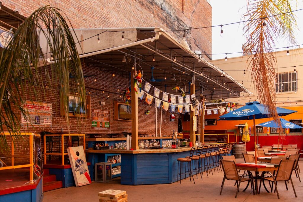 Lively outdoor bar setting with colorful decor and plenty of seating options for a vibrant atmosphere.